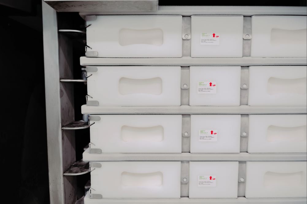 Stack of RoSS shells holding single-use bags inside. Shells are placed inside plate freezer RoSS.pFTU XL in preparation of freezing.
