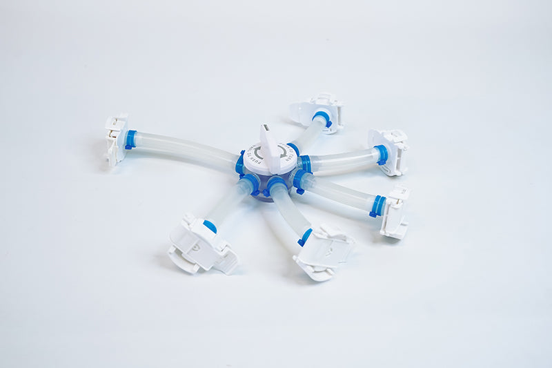 A single-use five way distributor on a white background.