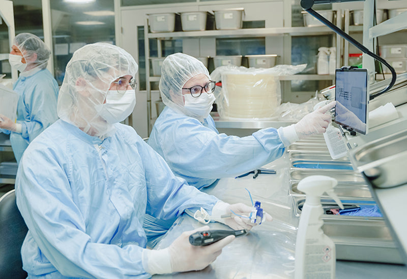 An image of two people working in an ISO 7-certified cleanroom, producing sterile single-use assemblies for biopharmaceutical applications.