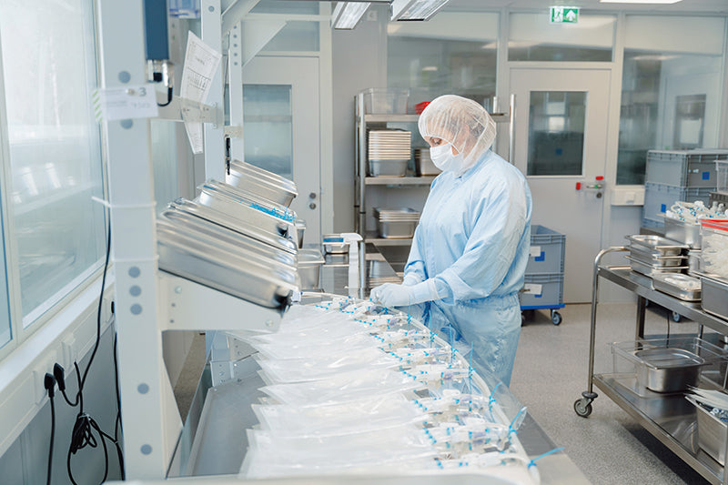 An image showing a person in a cleanroom environment assembling single-use bioprocess containers.