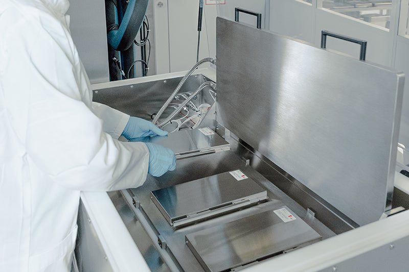 Close-up image of an operator placing RoSS.KSETs into a RoSS.pFTU Lab-Scale solution to freeze small volumes of drug substances.