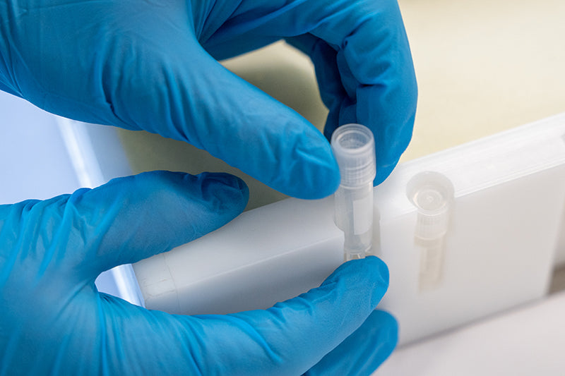 A detailed close-up of the sample integration of a RoSS Shell, with a person's hand in blue gloves domonstrating it.